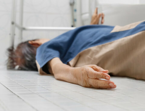 elderly woman lying on the floor in the bathtub having a seizure