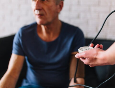 an elderly man is sitting on a sofa
