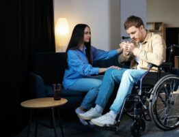 a girl helps a man with cerebral palsy