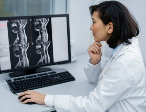 the doctor analyzes the MRI images of сervical Herniated Disc