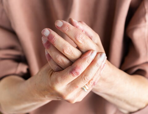 Elderly hands clasped together